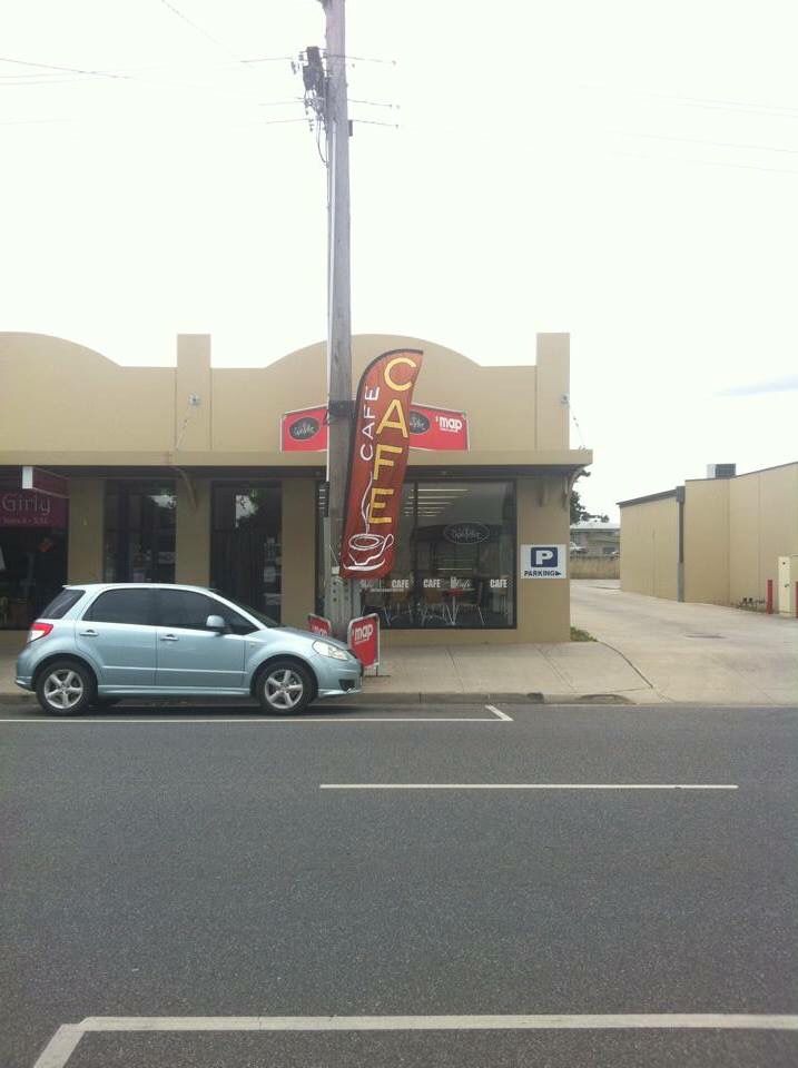 The Chandelier Cafe shopfront with feather banner and street parking
